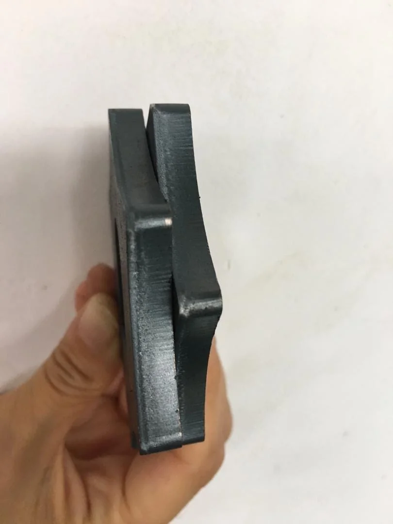 Metal fabrication laser cutting process with sparks flying from precise cut edge on steel plate